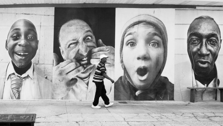 A man walks past the inside out photography project in the black and white image