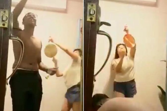 A Chinese lady chimes a gong in the background when an Indian man rings a bell for prayers.