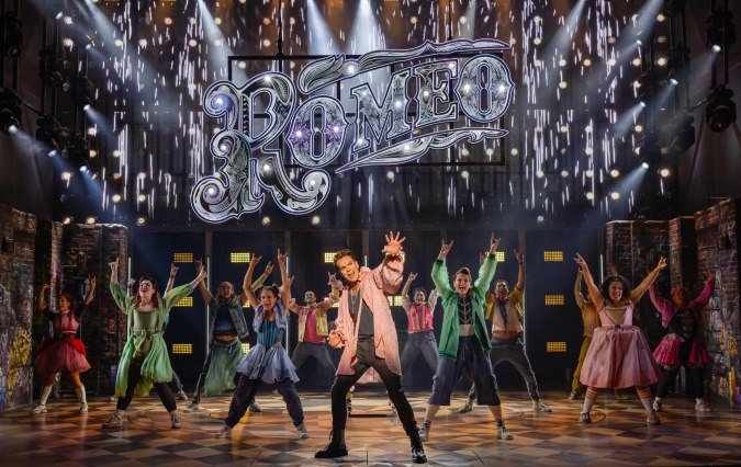 A cast dances with the character Romeo right up front, as part of the & Juliet musical. 